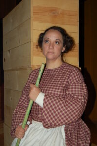 woman in gingham dress and apron
