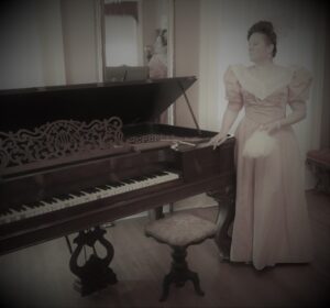 victorian woman next to a piano